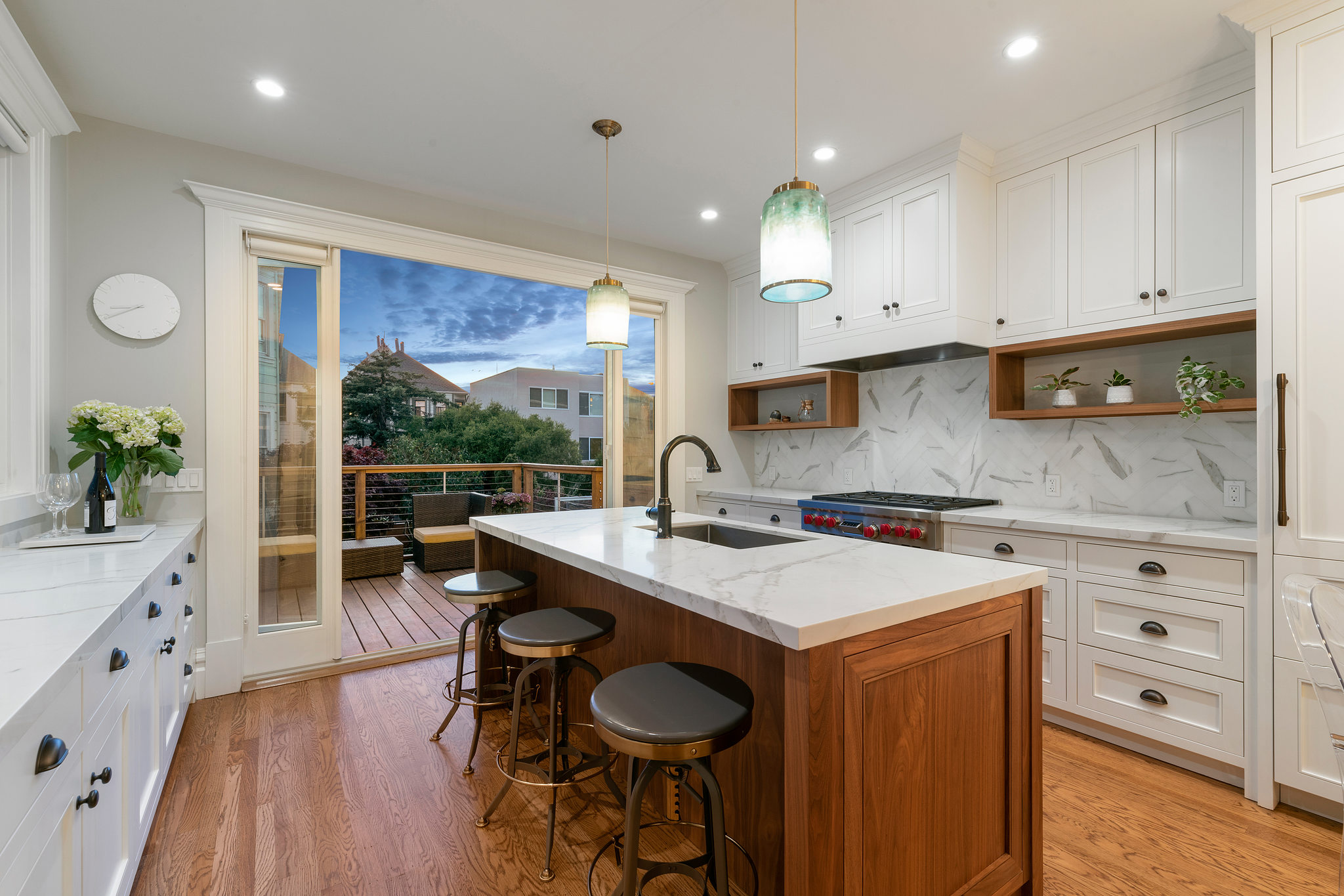View of a kitchen, featuring white cabinetry, center island, and patio