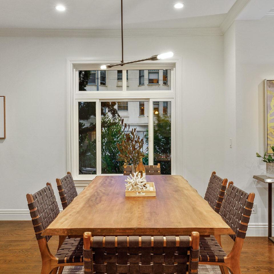 View of a dining room with a large wood table