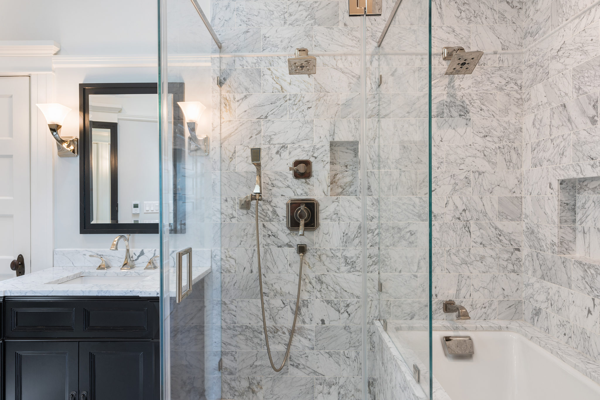 View of a bathroom with a sink, shower, and bathtub 